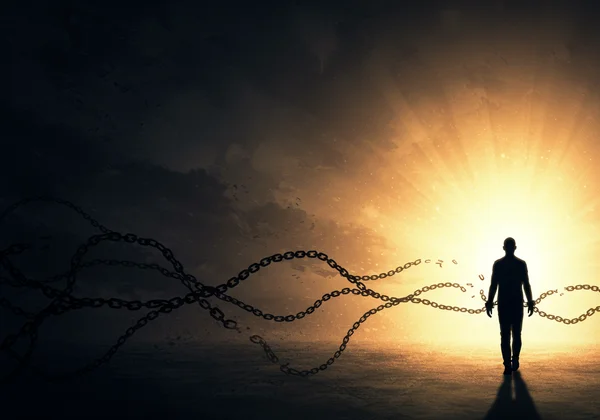 Person breaking chains, walking towards light, healing.
